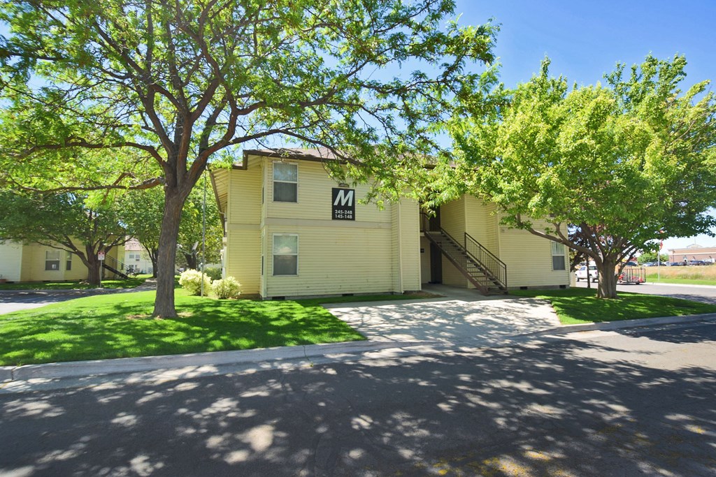 A yellow building with a black letter M on the front.