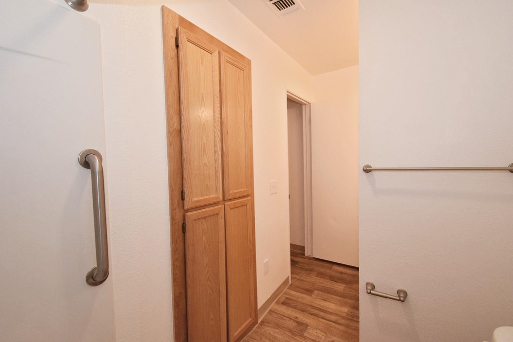 A white door with a silver handle is on the left side of the image.