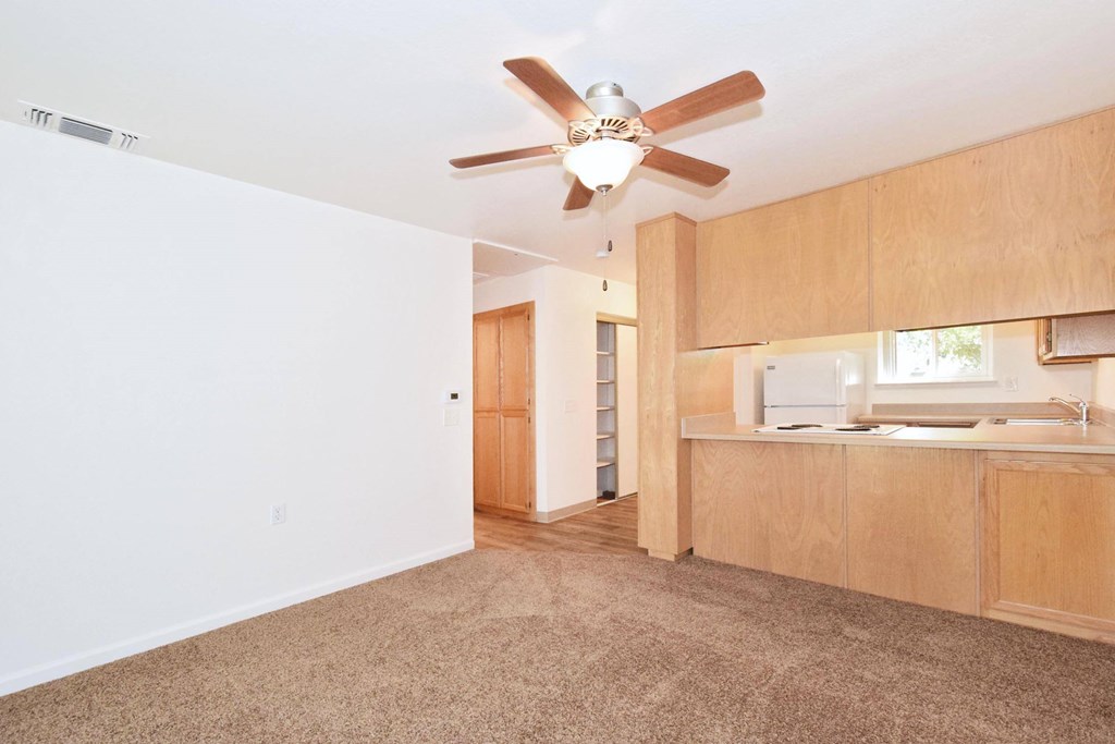 A room with a ceiling fan and a window.