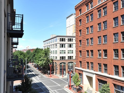 A city street with a red brick building on the right.