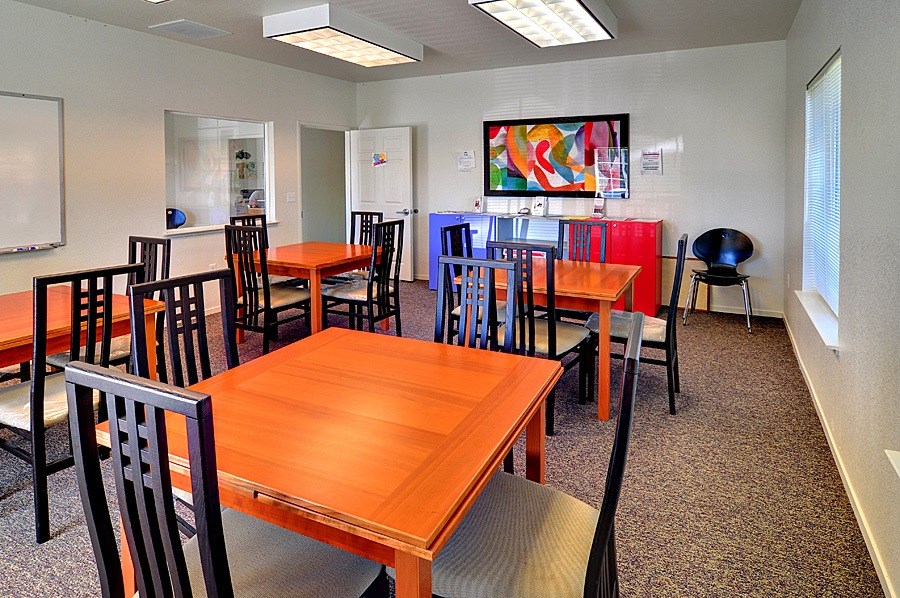 A conference room with a long table and chairs.