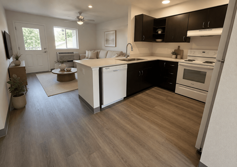 A kitchen with black cabinets and white appliances.