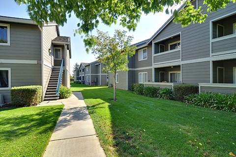 Apartment complex with a walkway in the foreground.