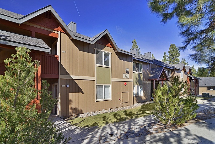 A row of houses with brown and beige exteriors.