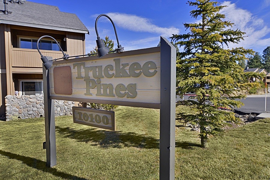 A sign for Truckee Pines stands in front of a house.
