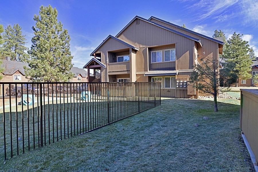 A large house with a black fence in front.