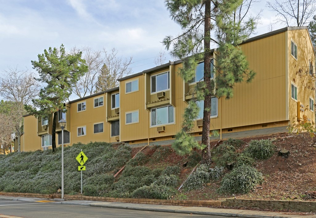 A yellow building with a yellow sign in front of it.