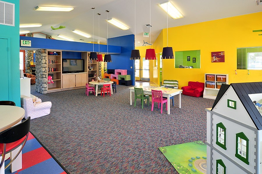 A colorful children's playroom with a variety of toys and furniture.