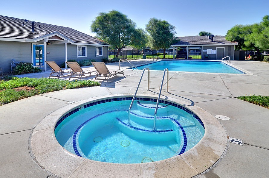 A small pool with a fountain in the middle of it.