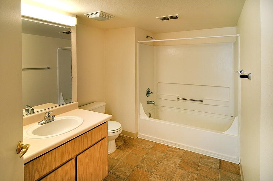A bathroom with a toilet, sink, and bathtub.