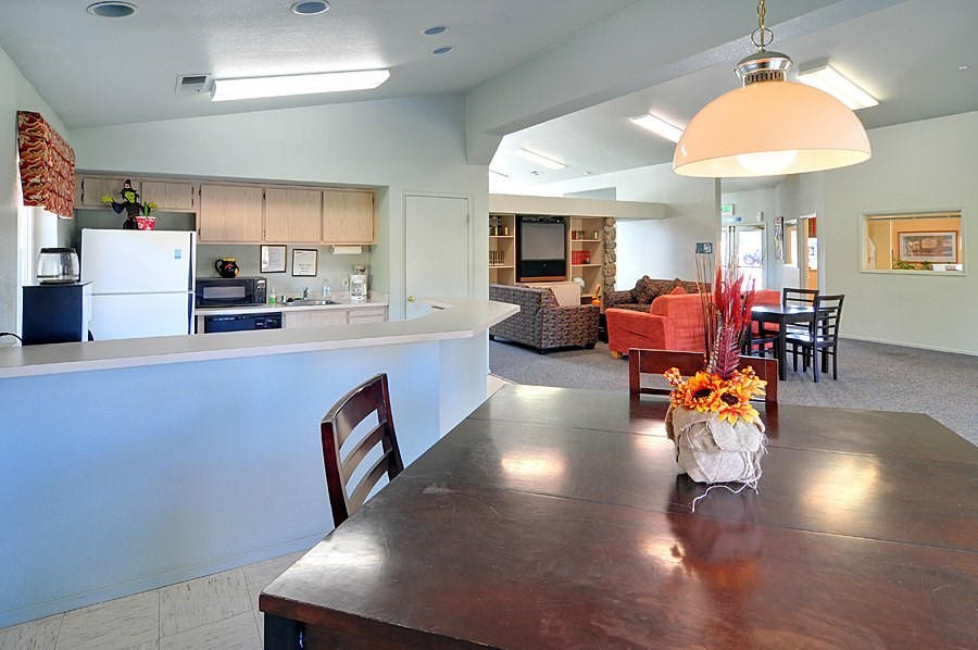 A kitchen with a table and chairs in the middle of the room.