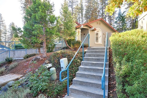 A house with a staircase leading to the front door.