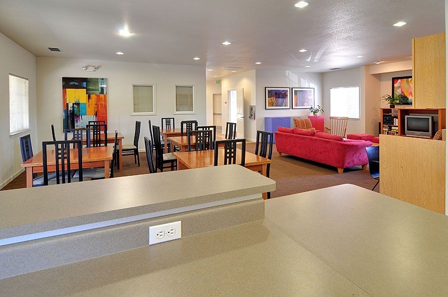 A living room with a red couch and a television.