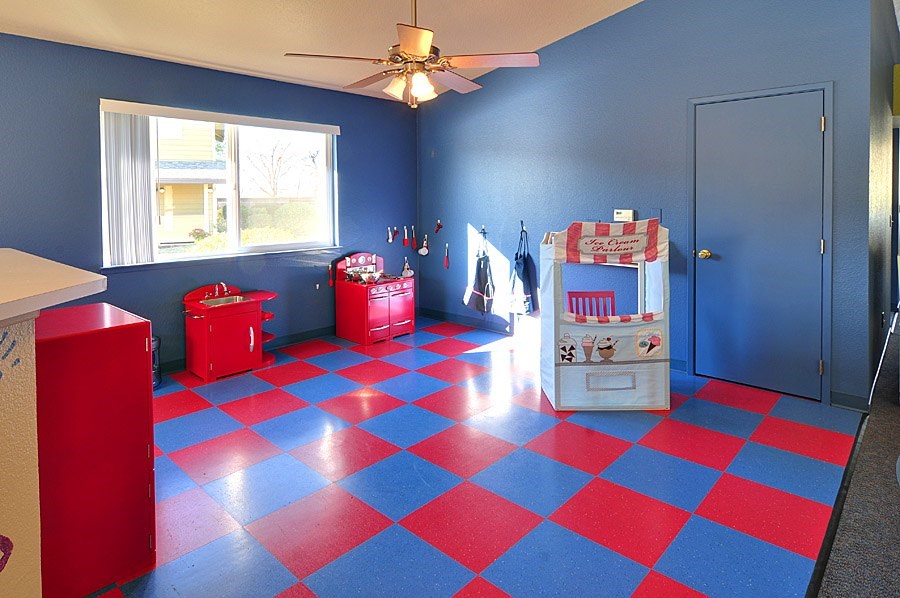 A room with a blue wall and a red and blue checkered floor.