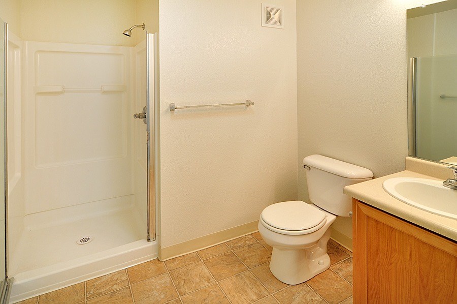A white toilet sits next to a sink in a bathroom.