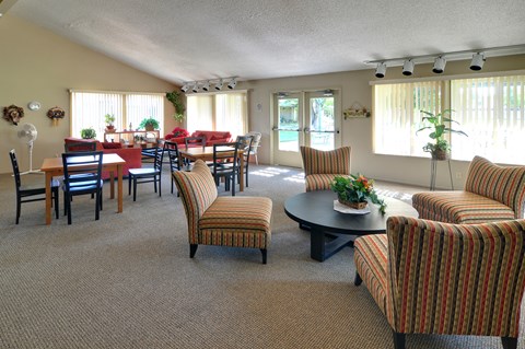 A living room with a dining table and chairs.