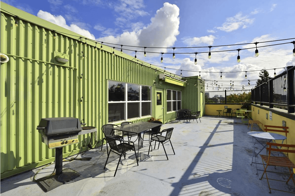 A patio with a table and chairs is set up on a rooftop.