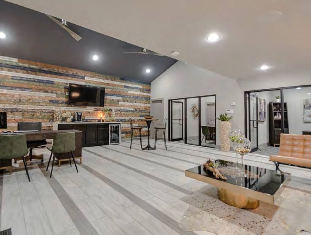 A modern living room with a wooden wall. at Infinity on the Landing Apartments, Euless, Texas