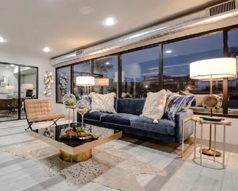 A modern living room with a blue couch and a coffee table.