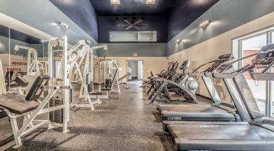 A gym with treadmills and exercise machines at Infinity on the Landing Apartments, Euless