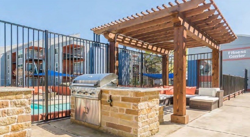 A fitness center with a wooden pergola and a trash can at Infinity on the Landing Apartments, Euless