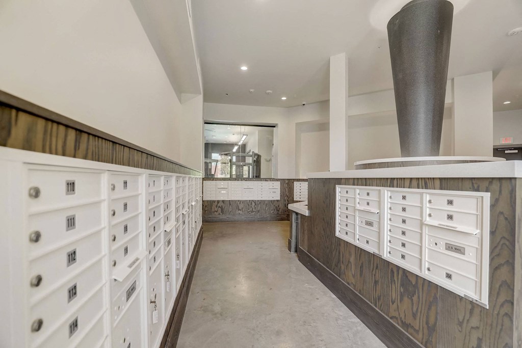 A long hallway with white drawers on the wall at Infinity on the Point Apartments, Dallas, TX