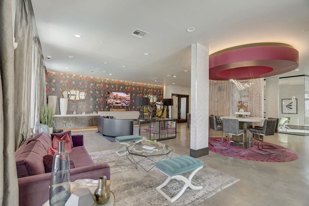 A living room with a red couch and a white coffee table at Infinity on the Point Apartments, Dallas, TX, 75243