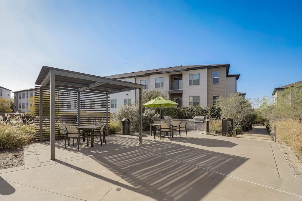 A sunny day at the outdoor seating area of a modern apartment complex at Infinity on the Point Apartments, Dallas