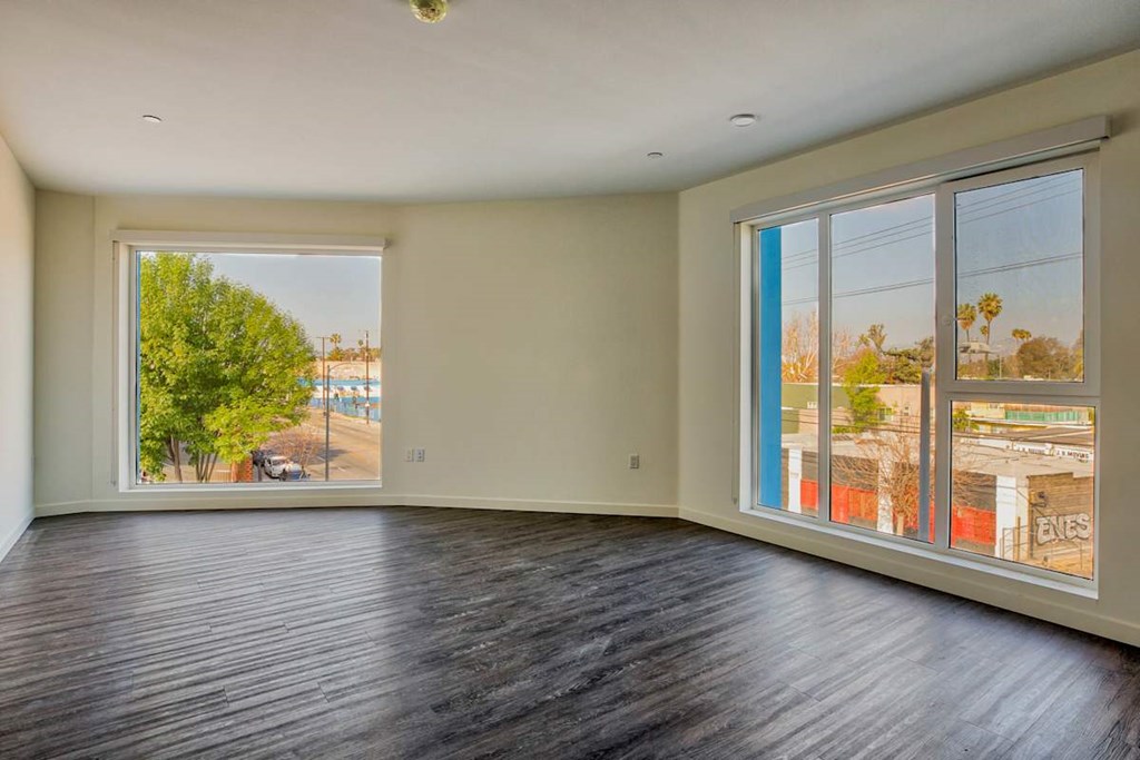 A room with a large window overlooking a street.at Catalina West Adams, California