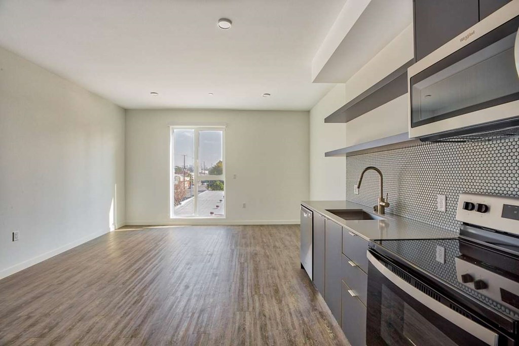 A kitchen with a stove top oven and microwave.at Catalina West Adams, California, 90016