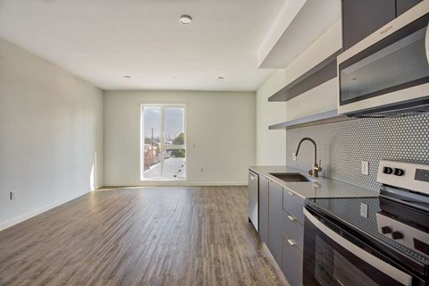 A kitchen with a stove top oven and microwave.