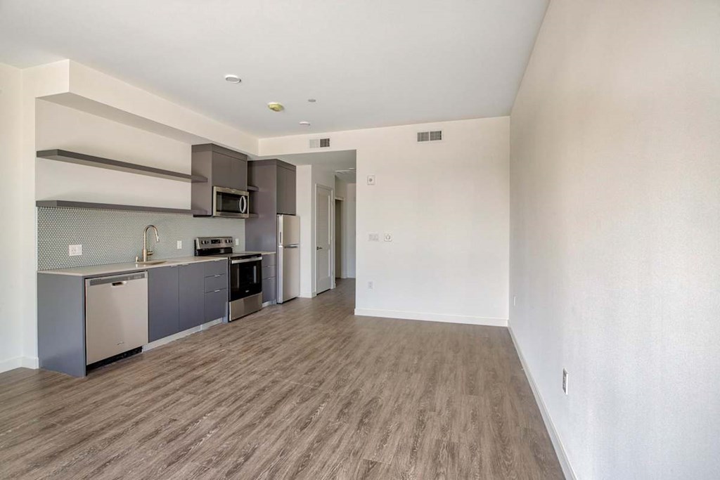 A kitchen with a refrigerator, oven, and microwave.at Catalina West Adams, Los Angeles