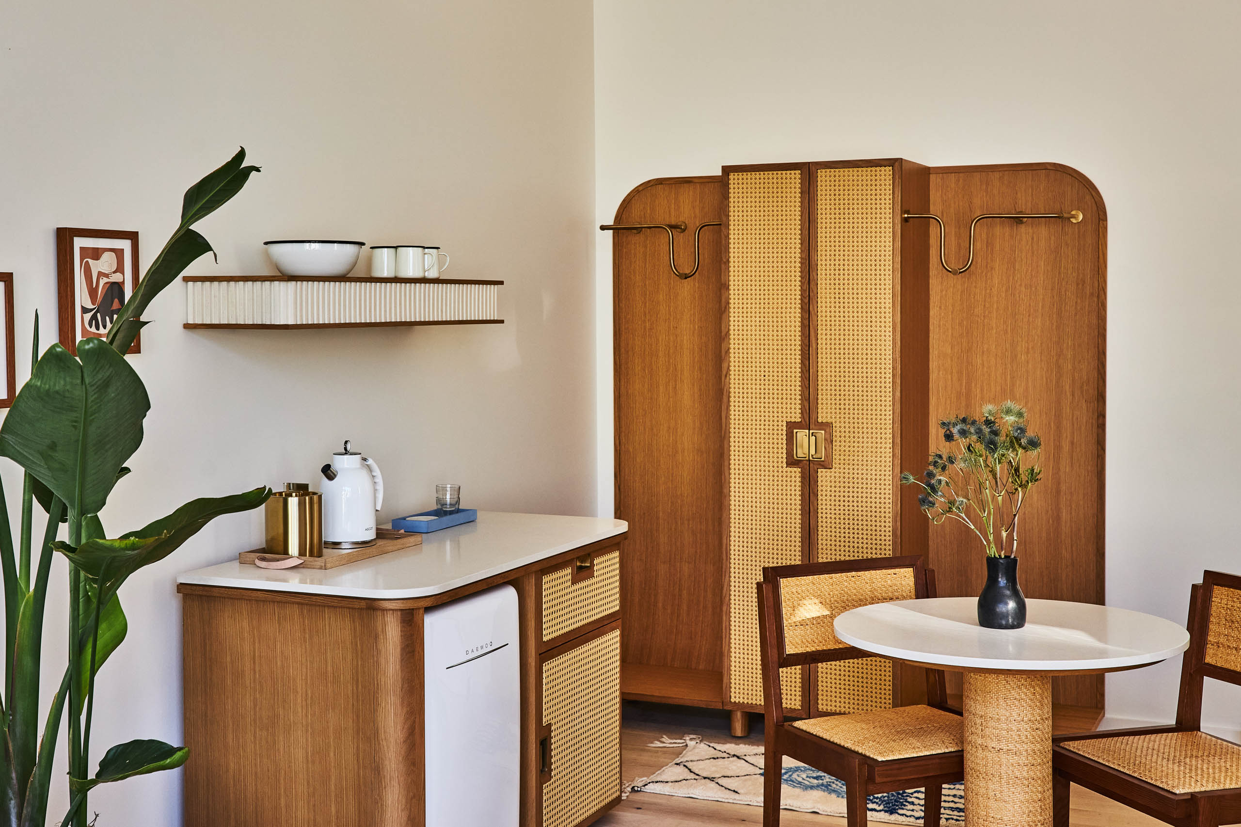 A kitchen with a table and chairs and a sink.