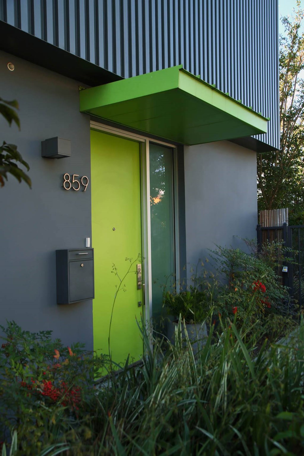 A green door is on the side of a building. at The Geffen, Los Angeles, CA