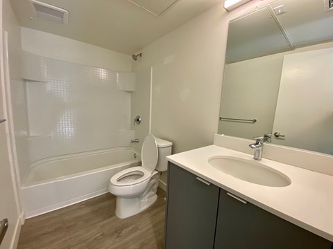 A white toilet sits next to a sink in a small bathroom.