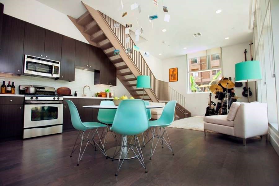 A modern kitchen with a dining table and chairs.at 1800 Whitley, Los Angeles California