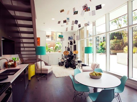 A modern kitchen with a dining table and chairs.