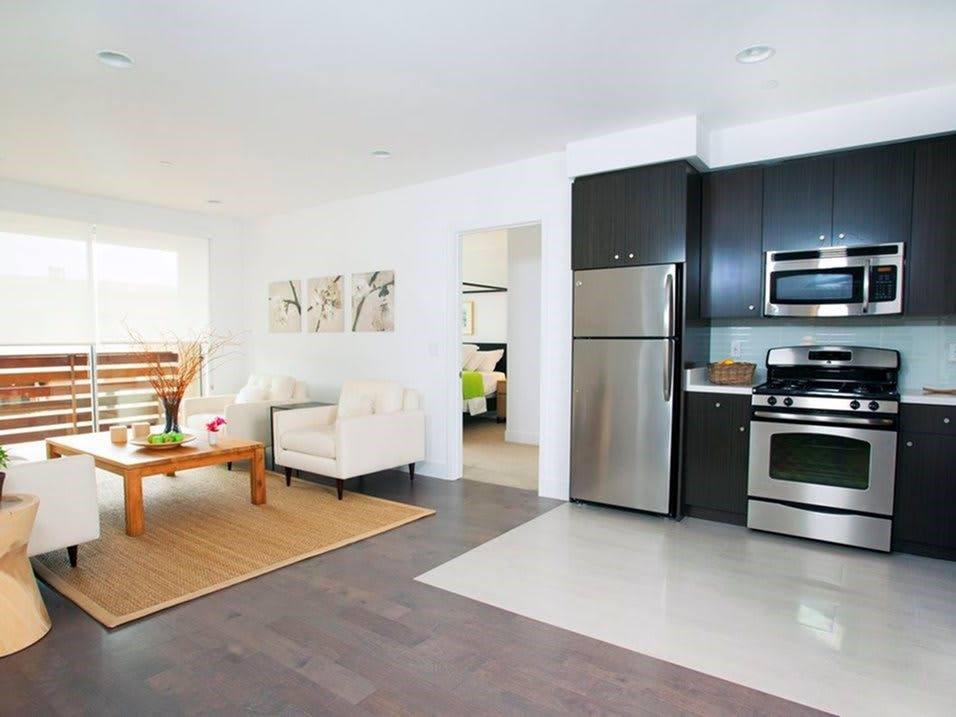 A modern kitchen with a refrigerator, oven, and microwave.at 1800 Whitley, California