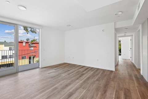 A spacious room with wooden flooring and white walls.at The Wilson, California, 90405
