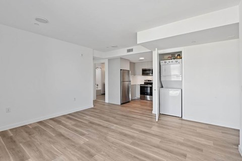 A kitchen with white appliances and wooden floors.at The Wilson, Santa Monica, CA 90405