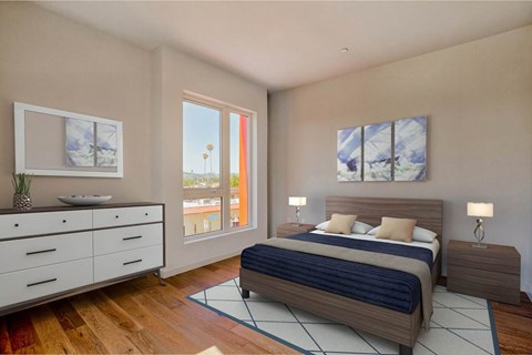 A bedroom with a bed, nightstand, and dresser.