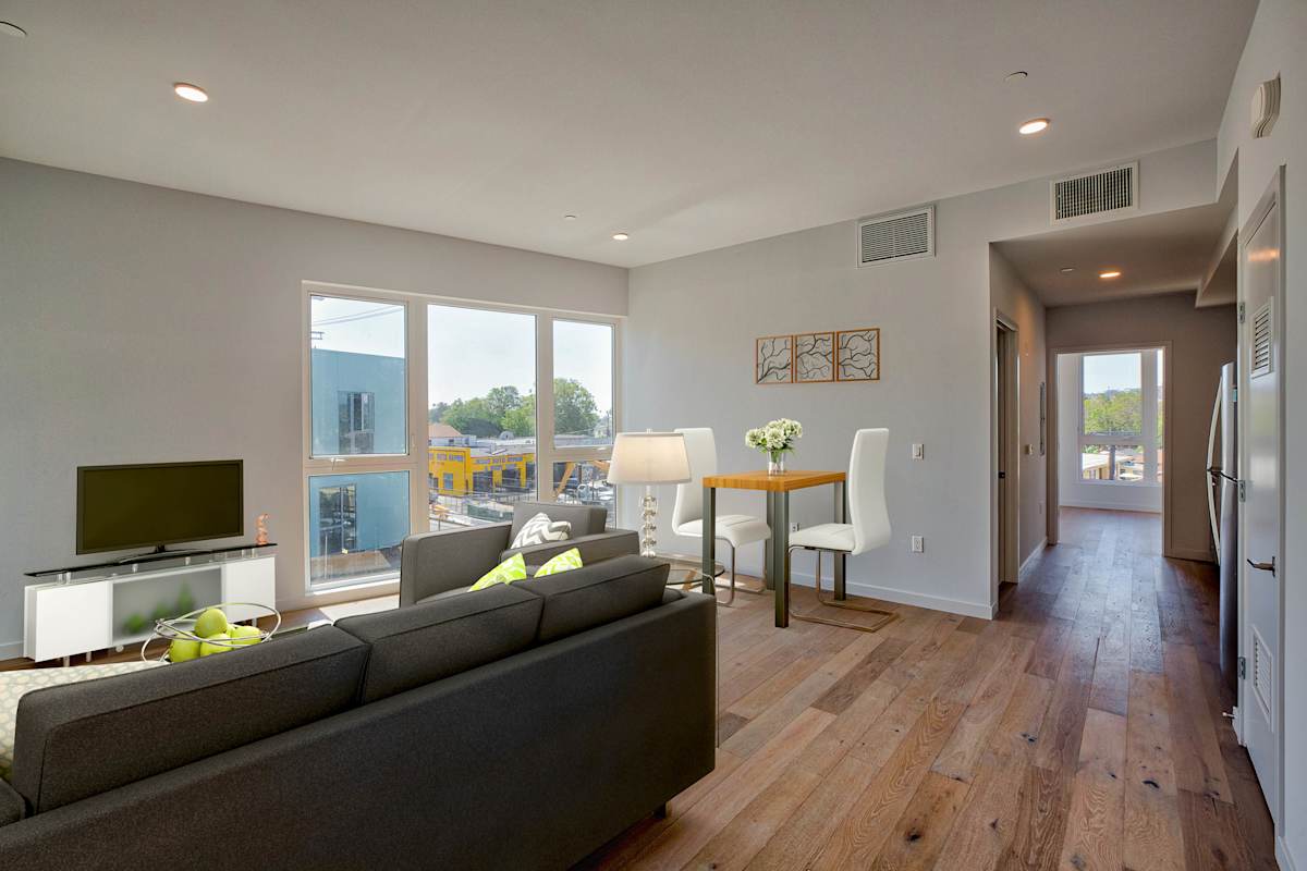 A living room with a grey couch and a television.