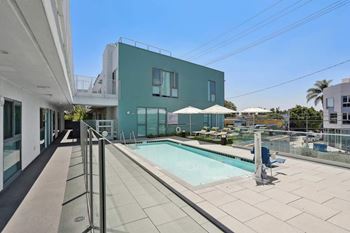 A modern building with a pool in the foreground.