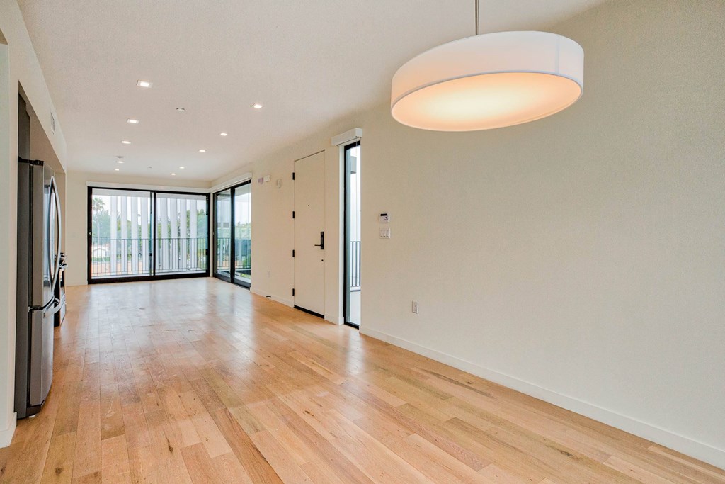 A spacious room with wooden floors and a large window.at 810 Ashland, Santa Monica California