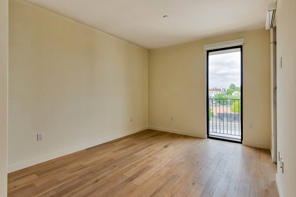 Empty room with wooden floor and sliding glass door.at 810 Ashland, California