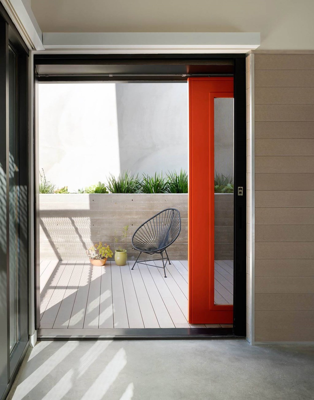 A red door opens to a balcony at 810 Ashland, Santa Monica, CA