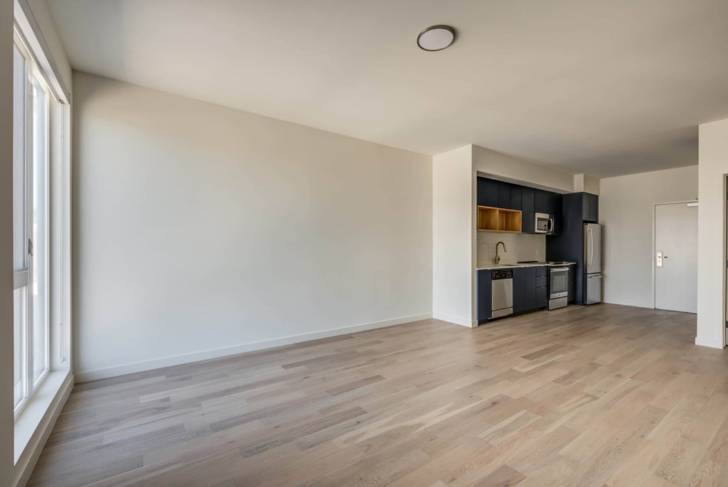 A room with wooden flooring and white walls.at Junction 4121, Los Angeles California