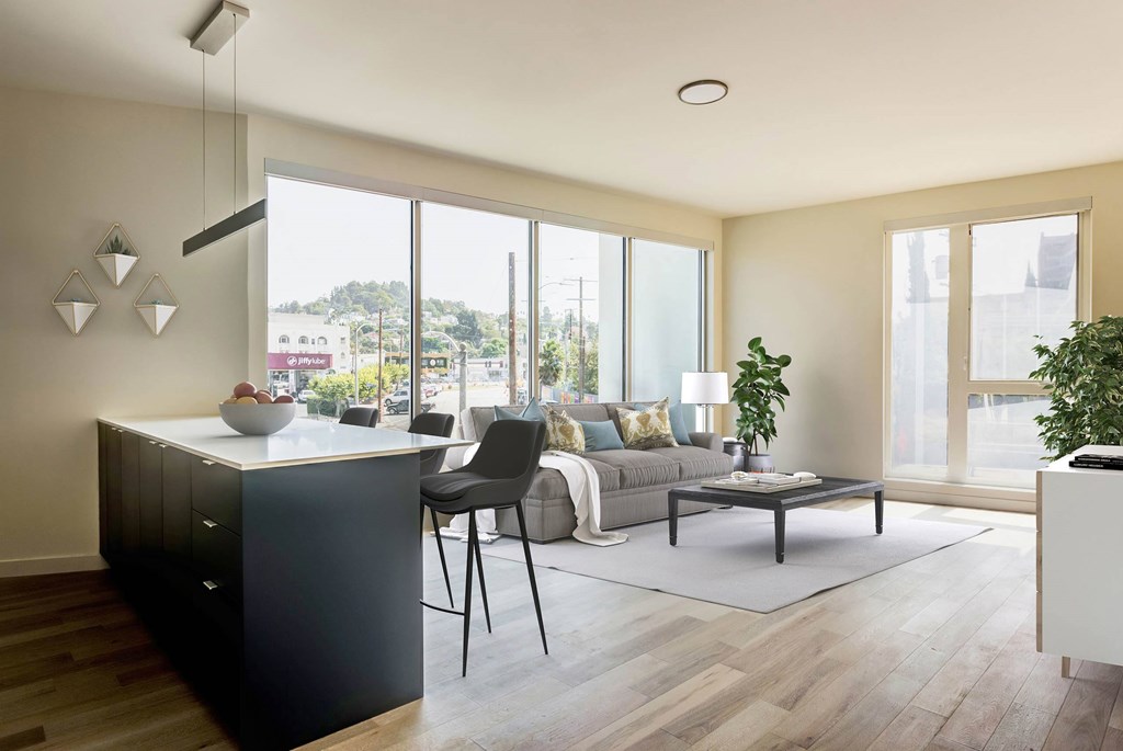 A modern kitchen with a black cabinet and a dining table with chairs.at Junction 4121, California, 90029