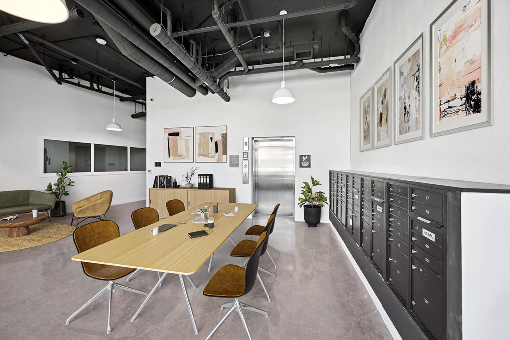 A conference room with a long table and chairs.