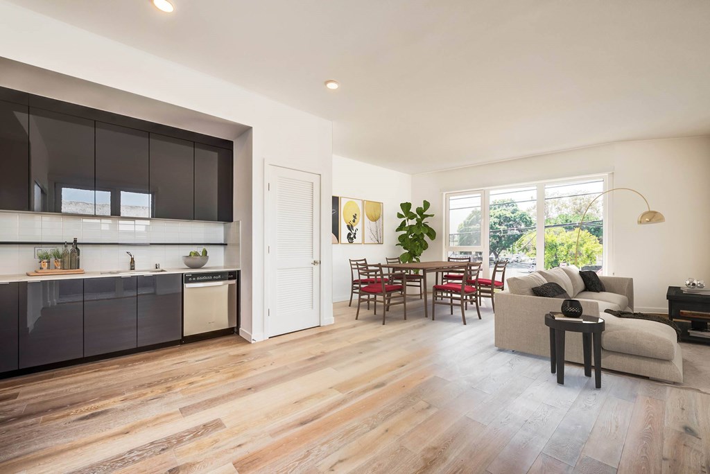 A modern kitchen with dark brown cabinets and a white countertop.at 5263 W Adams, Los Angeles, 90016